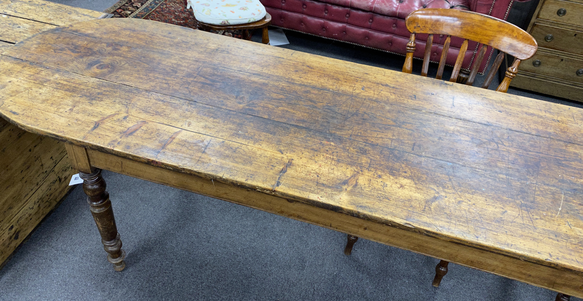 A 19th century French elm and fruitwood farmhouse table the triple planked top on six turned tapered legs, length 370cm, depth 67cm, height 73cm